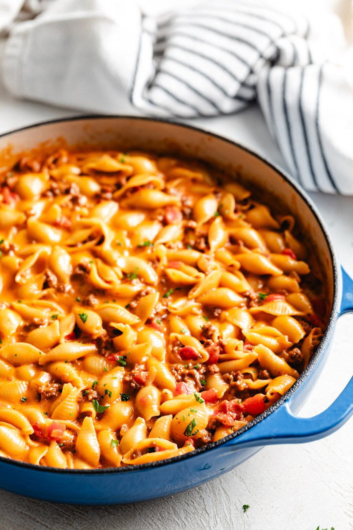 Side view of ground beef and cheese pasta in a pan.