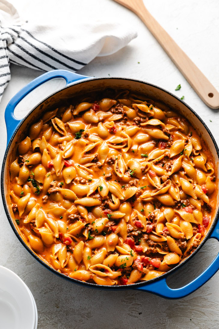 Overhead view of cheeseburger pasta in a blue skillet.