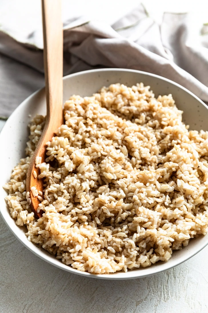 Side view of brown rice in a serving dish.