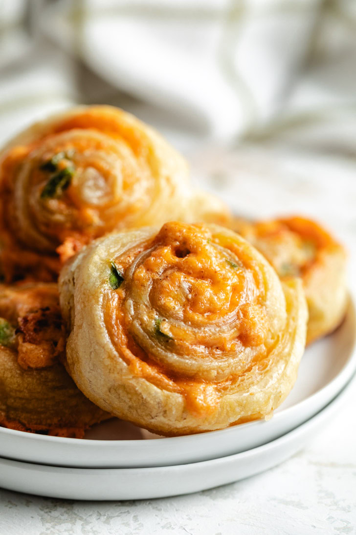 Plates filled with puff pastry pinwheels.