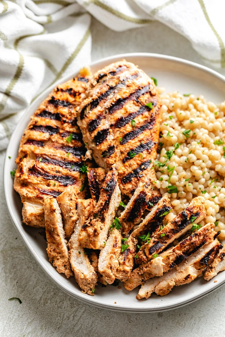 Yogurt marinated chicken cut into slices.