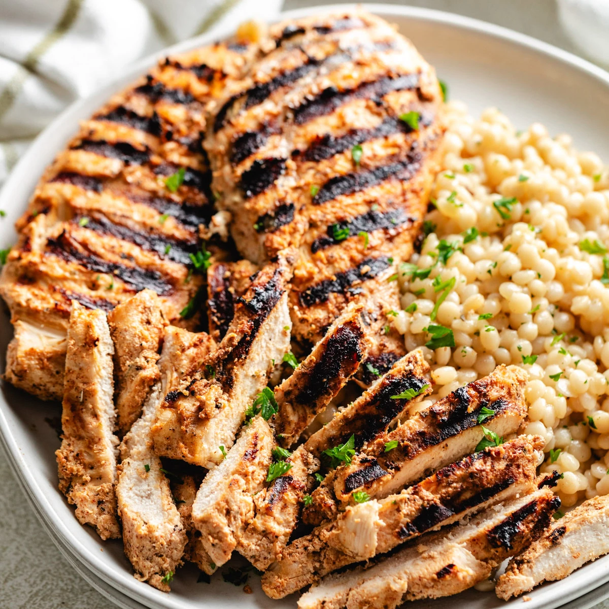 Close up view of a plate of yogurt marinated chicken.