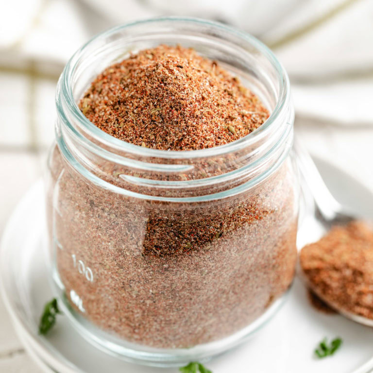 A glass jar filled with a homemade spice blend.