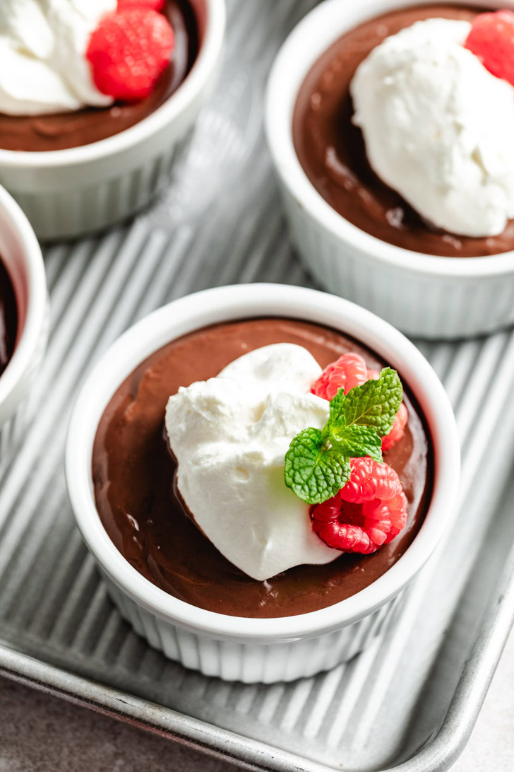 A close-up of a single ramekin with a chocolate dessert.