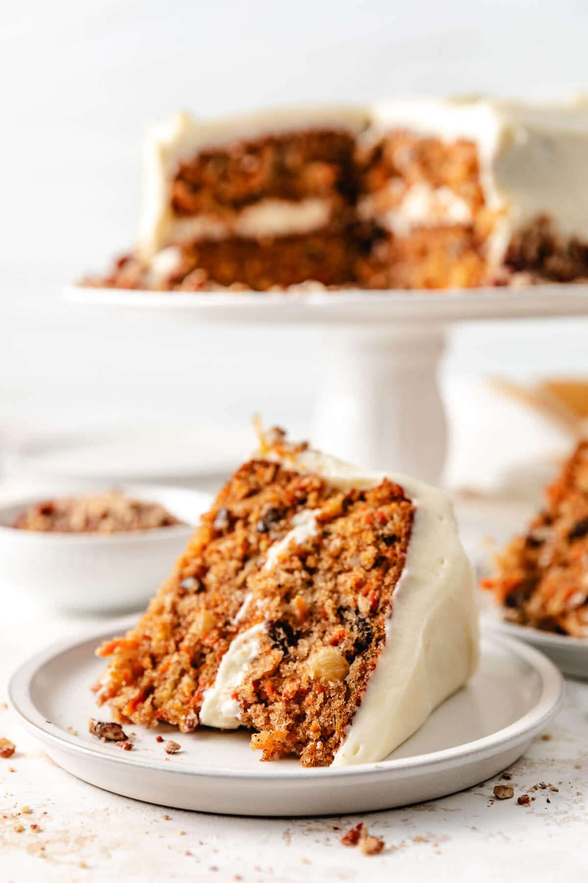 Slices of carrot cake on plates.