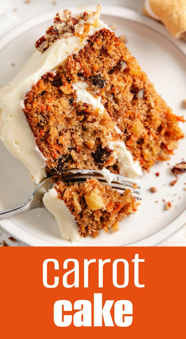 Close up view of carrot cake being sliced with a fork.
