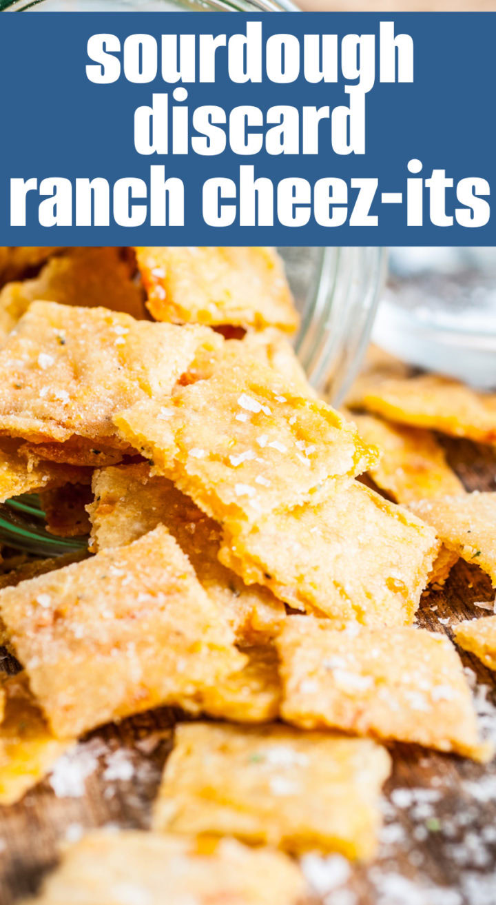 Cheesy crackers spilled out of a jar.