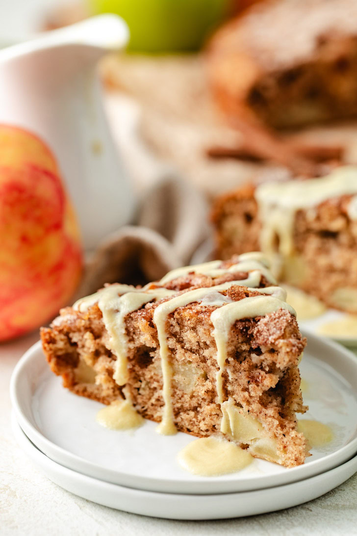 A slice of Irish apple cake on a white plate.