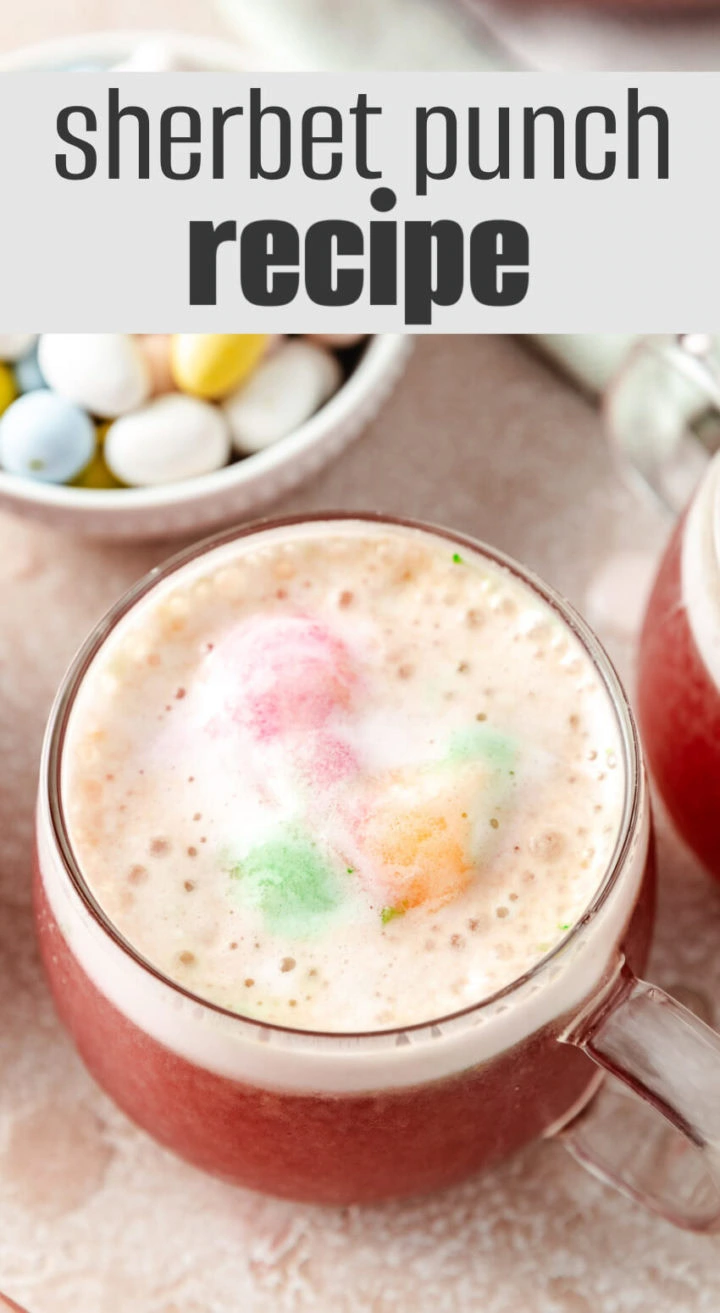 A scoop of melting rainbow sherbet in a glass of punch.