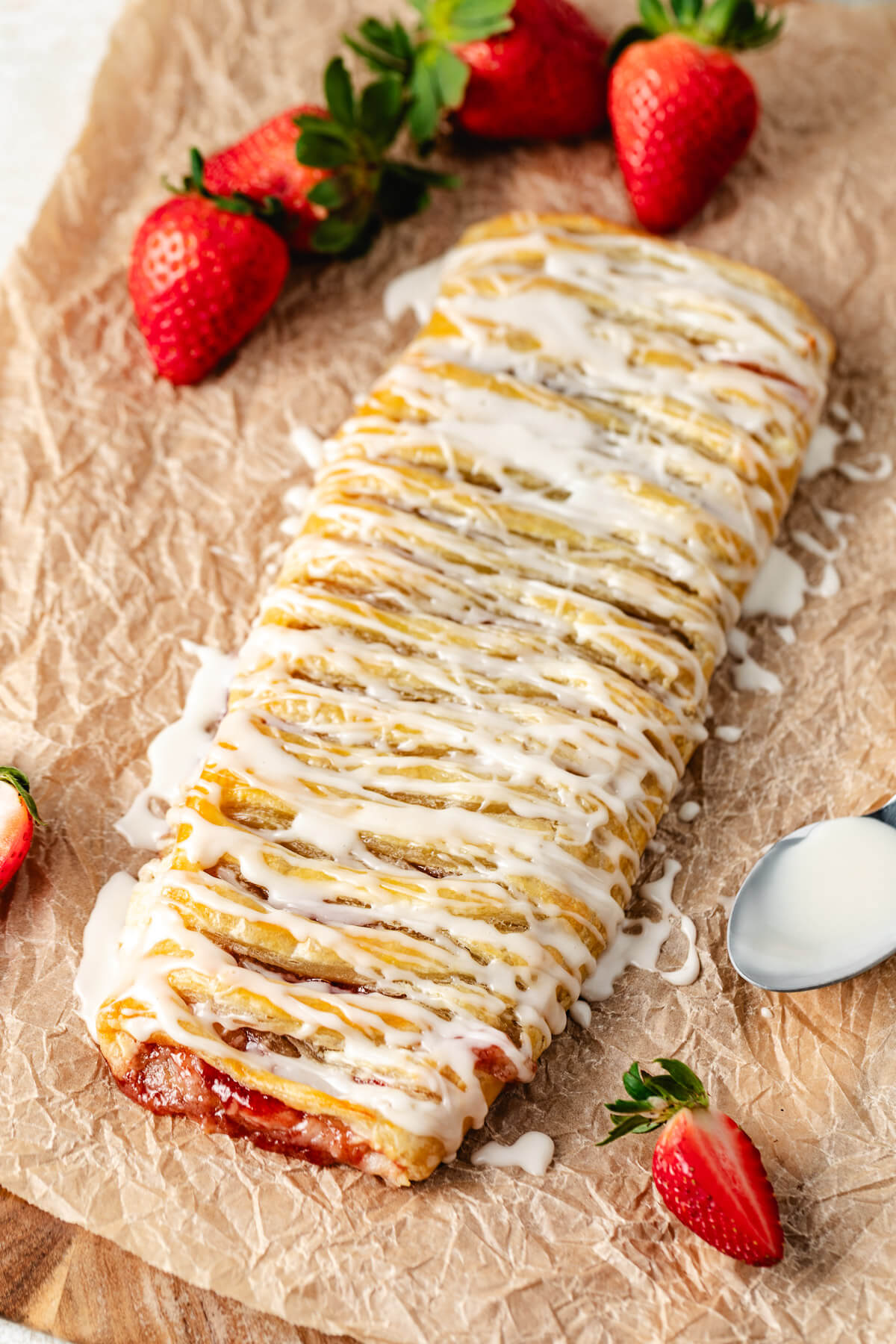 Overhead view of strawberry danish with puff pastry next to a spoon.