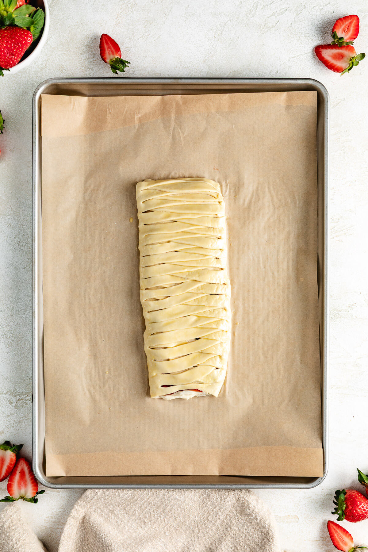 Egg wash applied to strawberry puff pastry.