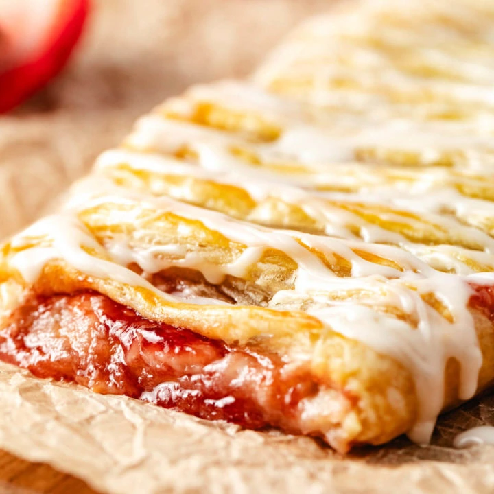 Close up of strawberry puff pastry on parchment.
