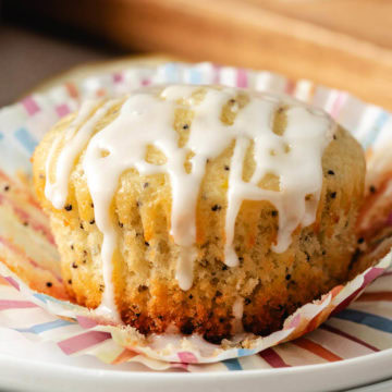 Close up view of a lemon poppy seed muffin on plates.