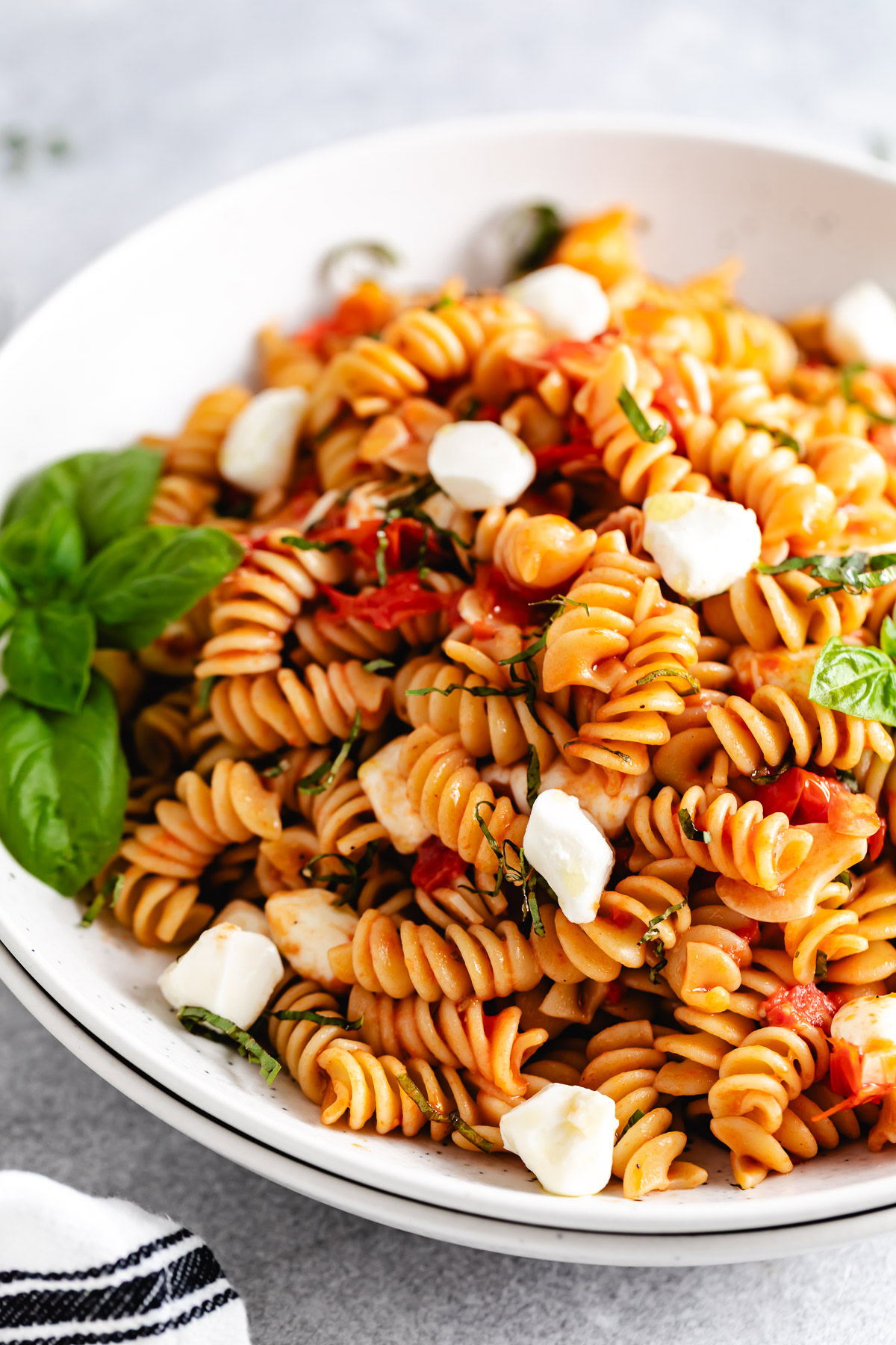 Caprese pasta with cheese and basil.