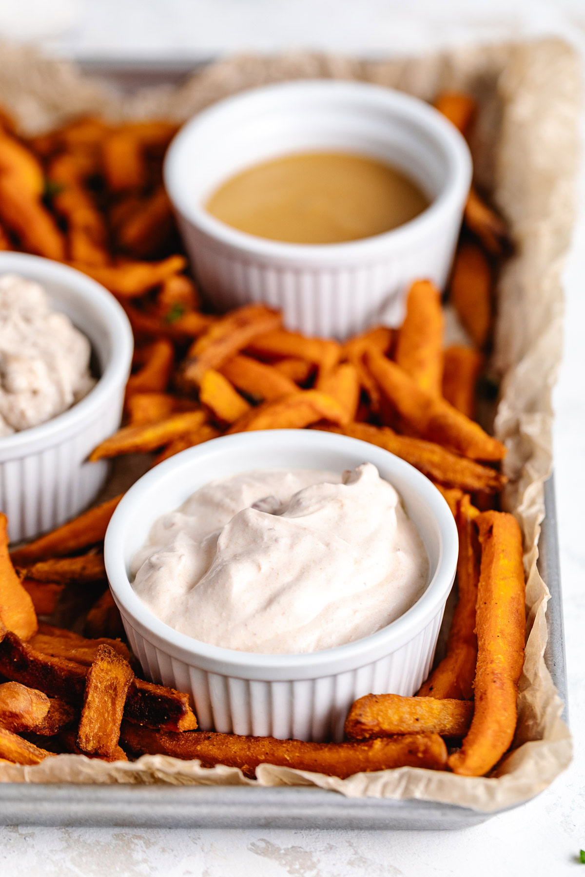 A tray of food with dipping sauces.