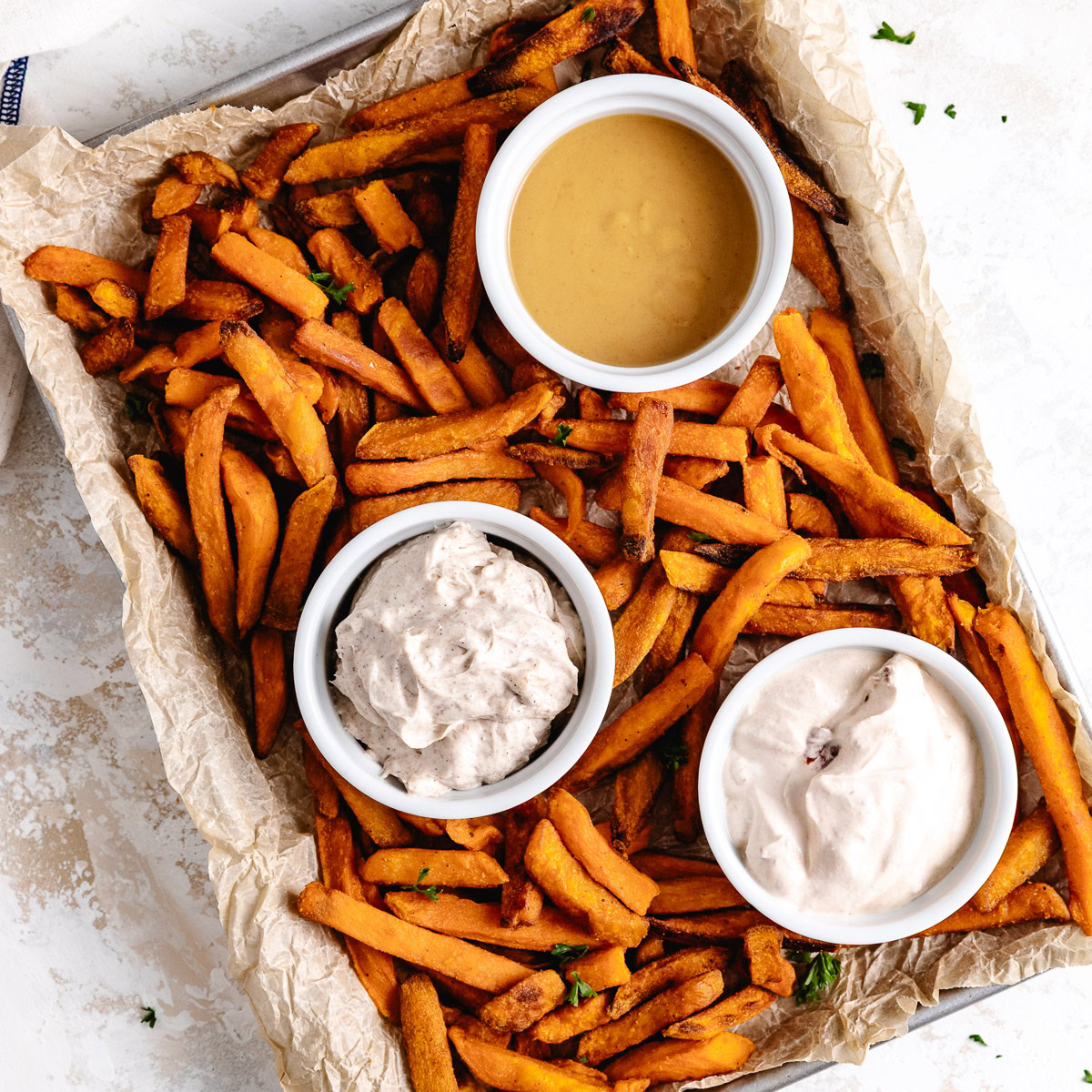 Sweet potatoes fries with three different dipping sauces.