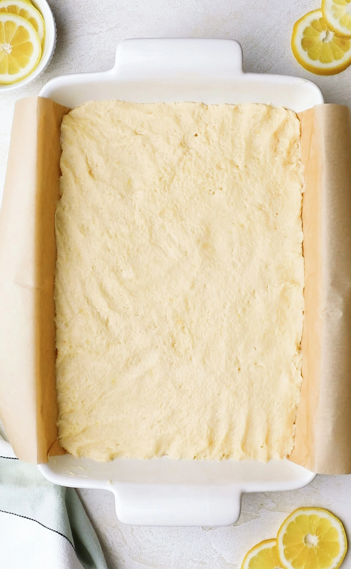 Lemon cookie bar batter in a baking dish.