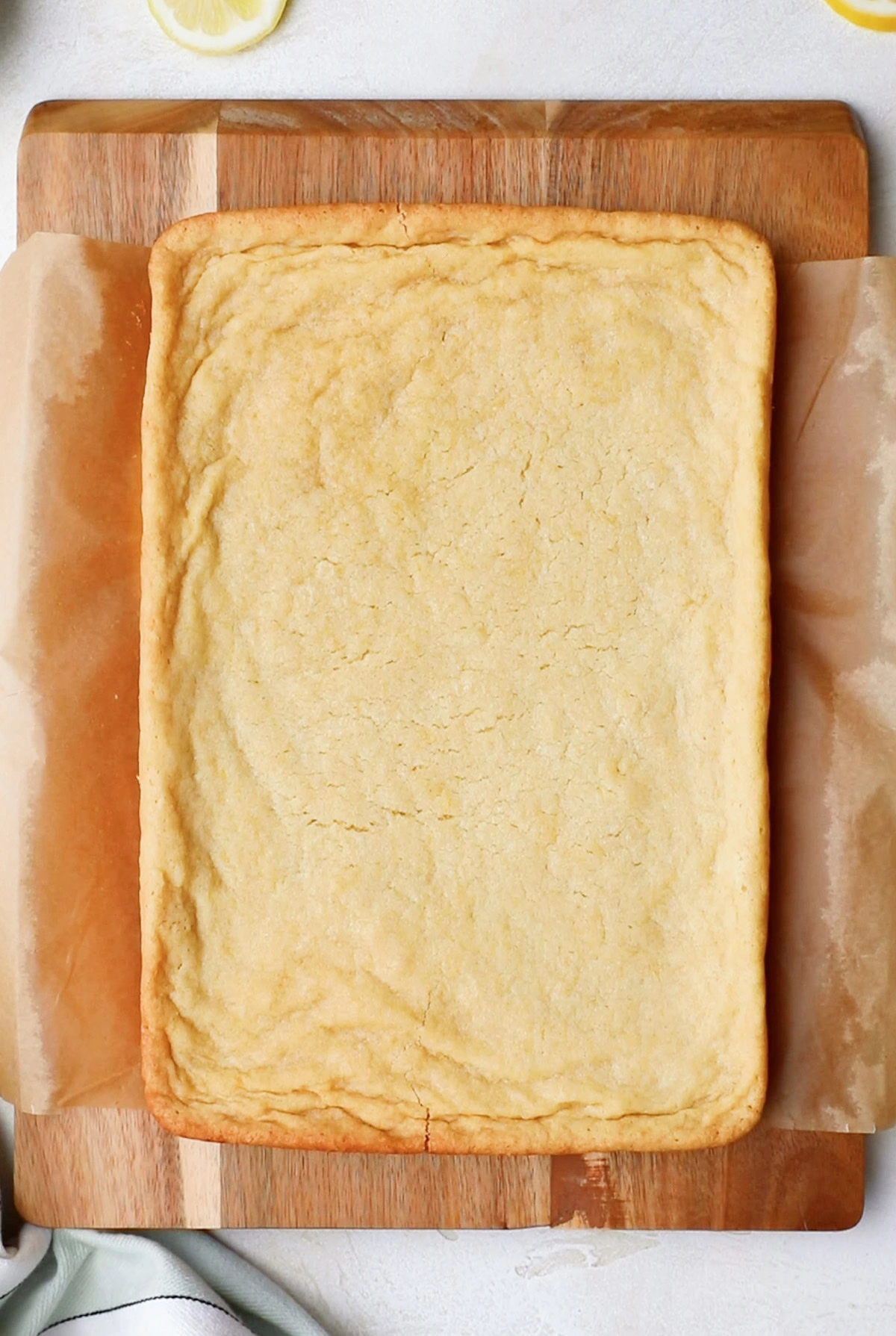 A rectangle of lemon bars on a cutting board.