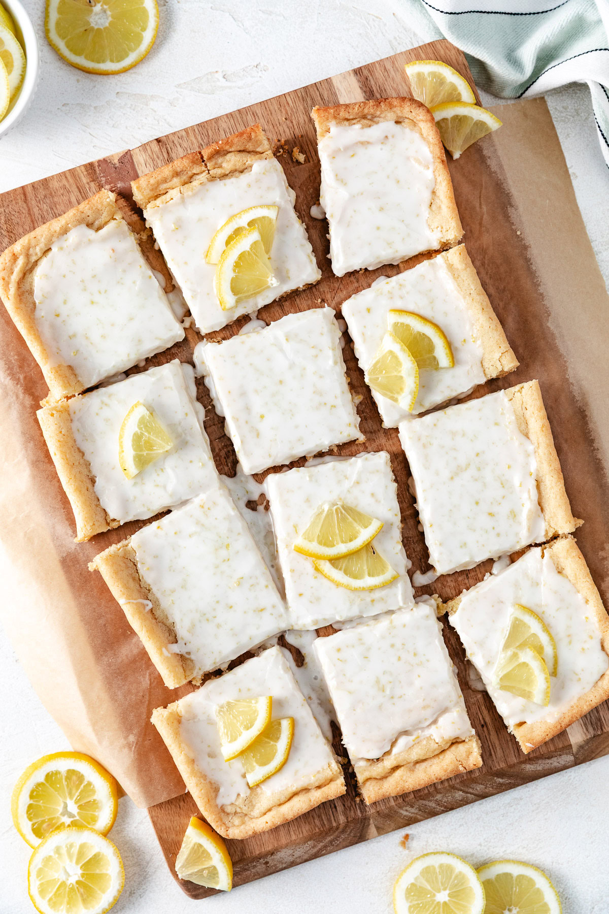 Lemon Cookie Bars A cutting board with slices of lemon cookie bars.