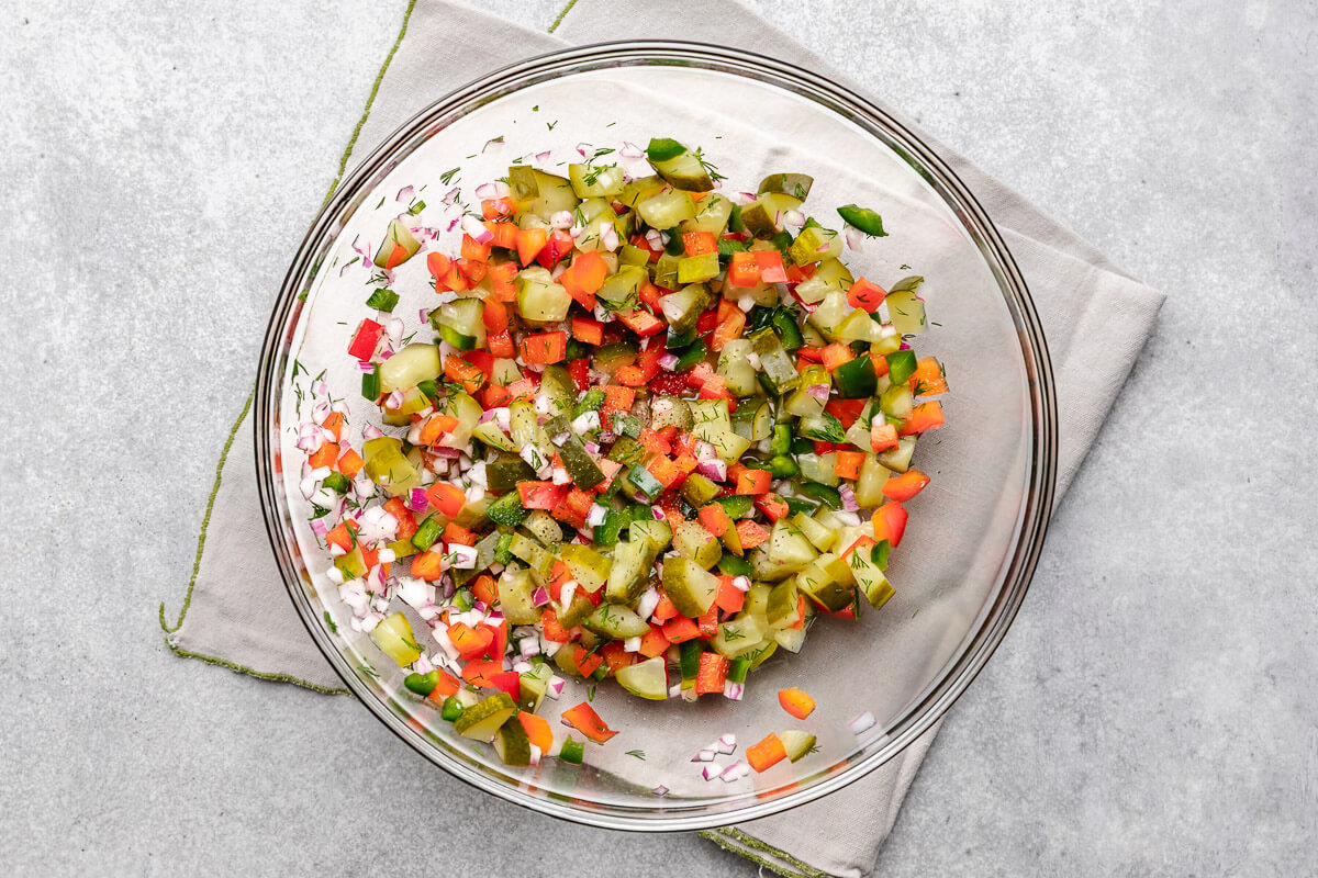 Pickle De Gallo Pickle salsa ingredients stirred together in a bowl.