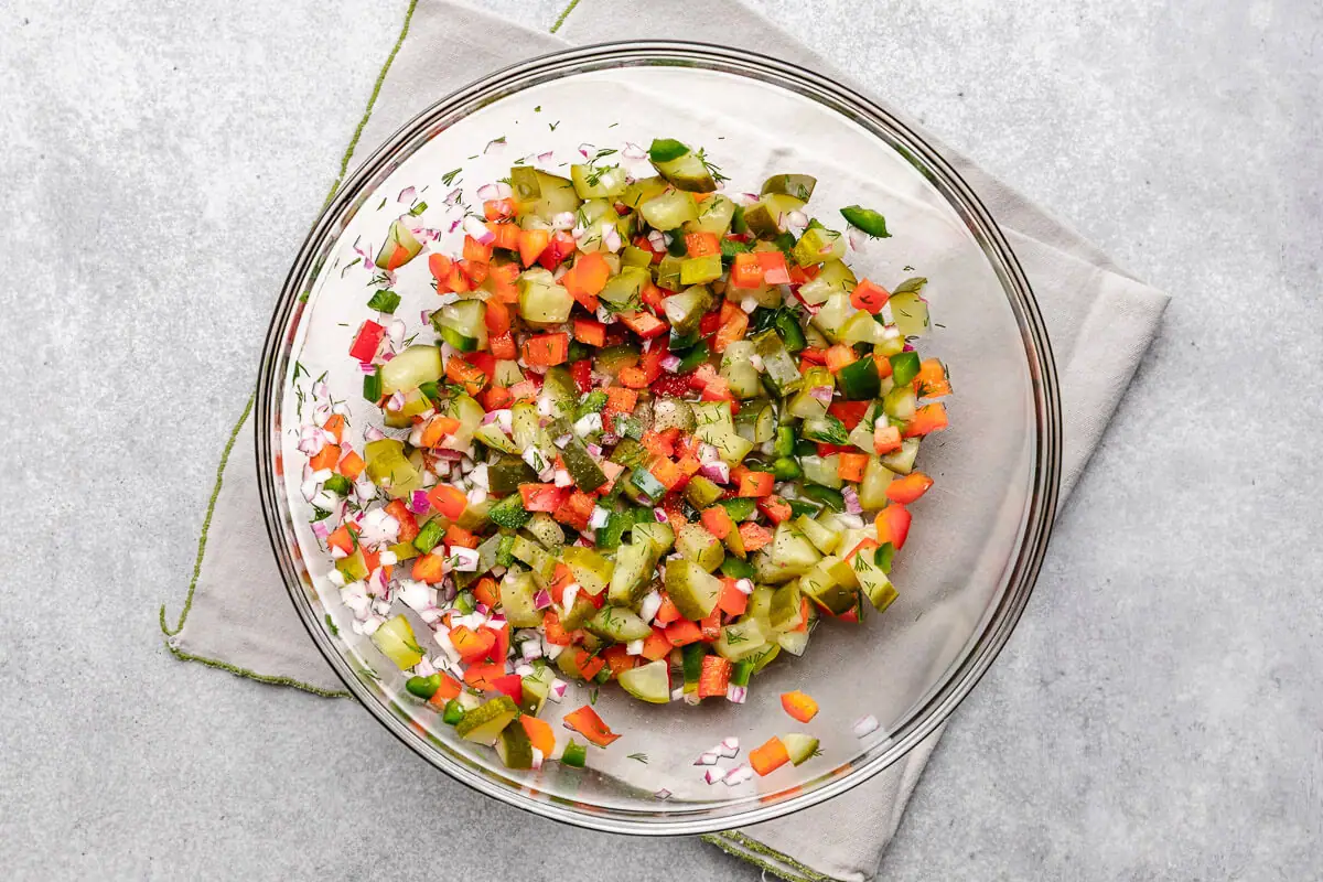 Pickle De Gallo Pickle salsa ingredients stirred together in a bowl.