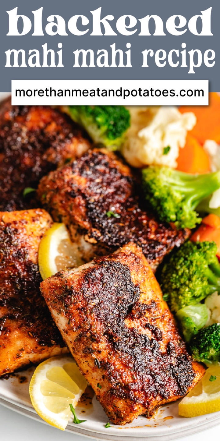 Close up view of blackened mahi mahi with sliced lemons.
