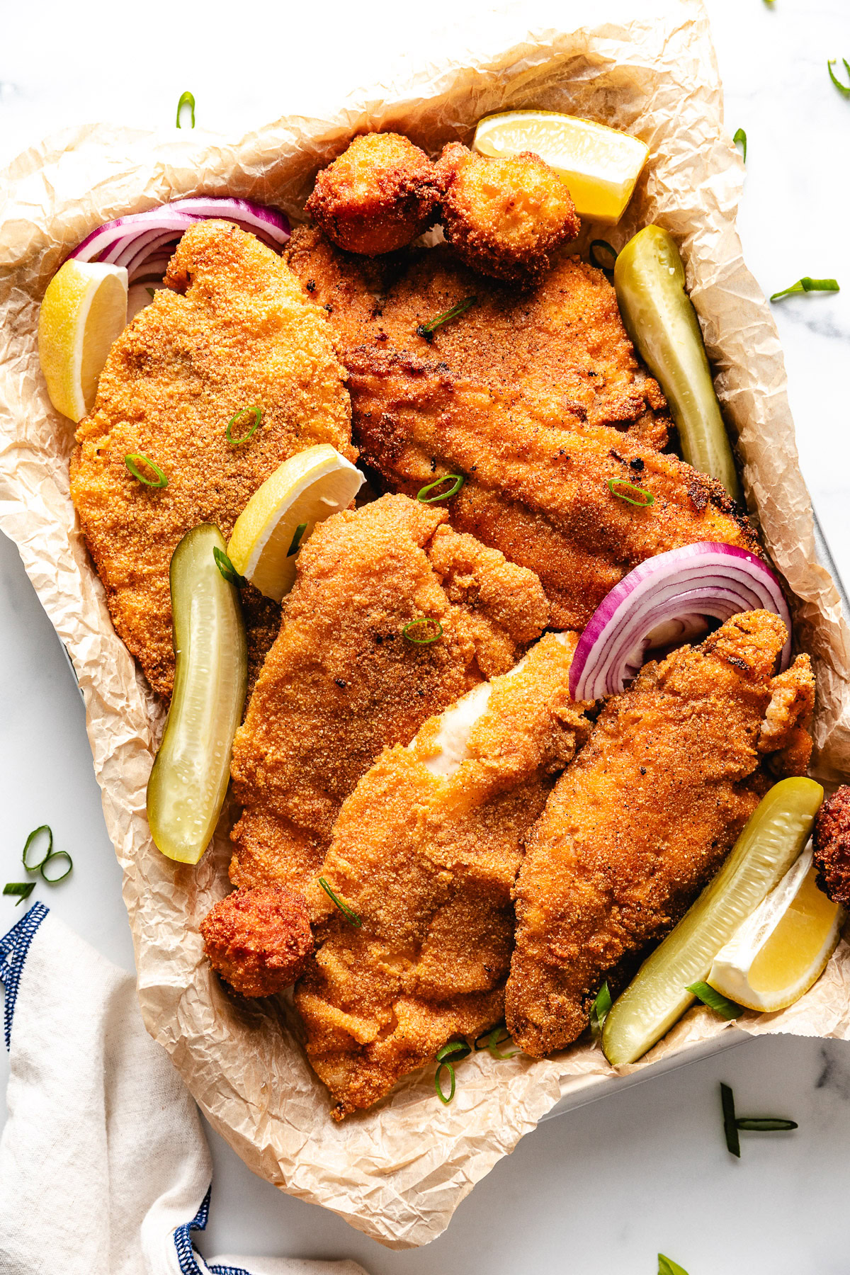 Overhead view of a pan of fried catfish.