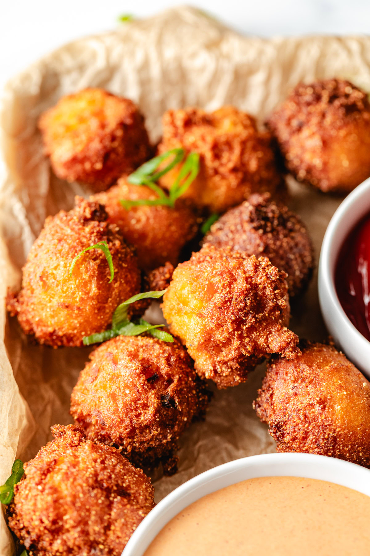 Fried hush puppies on a pan.