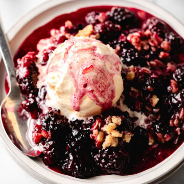 Close up view of blackberry crisp on a plate.