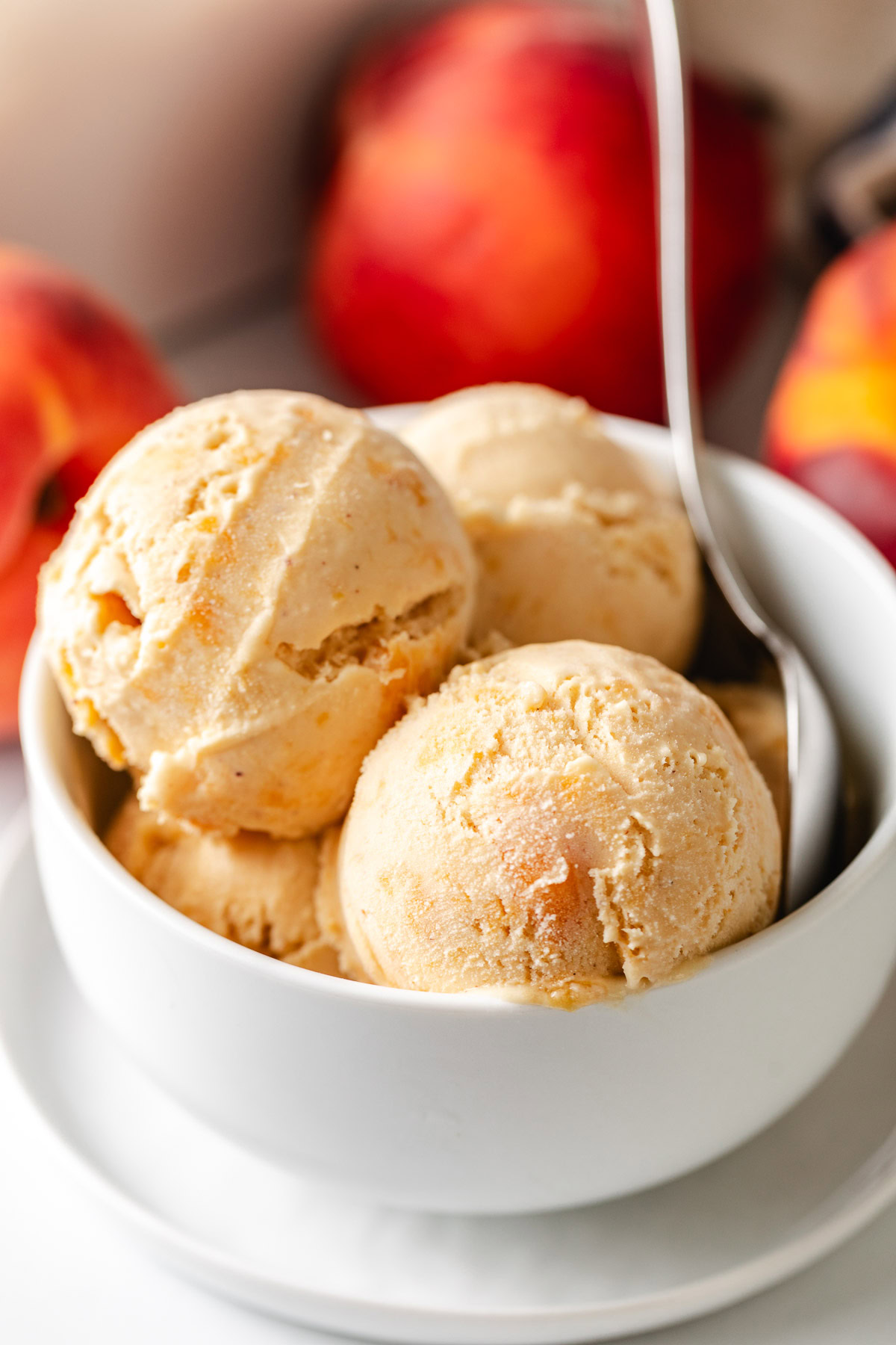 Peach ice cream in a bowl.