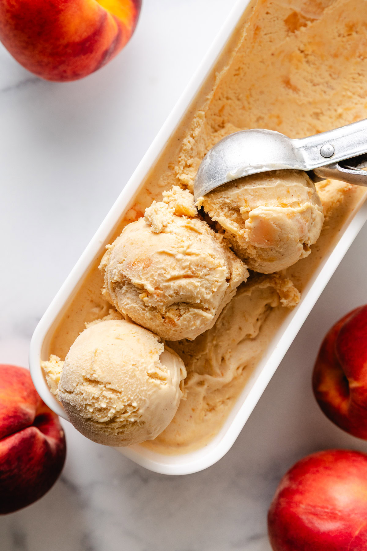 Brown Sugar Peach Ice Cream Three scoops of fresh peach ice cream.