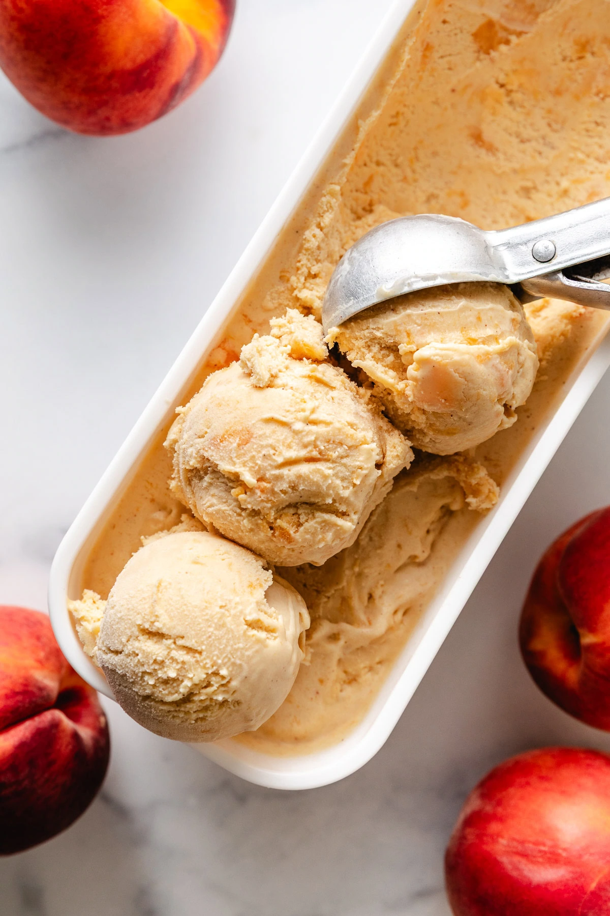 Three scoops of fresh peach ice cream.