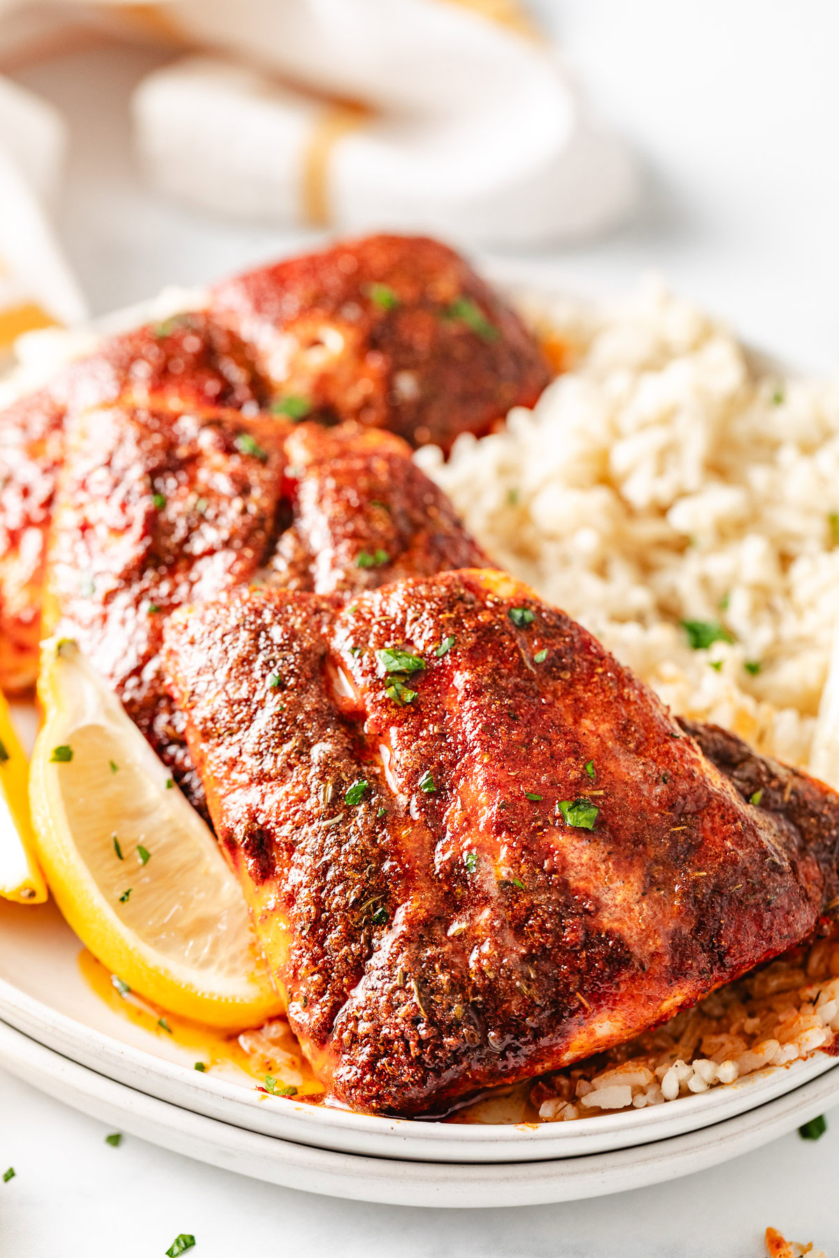 Blackened snapper on a plate with rice.