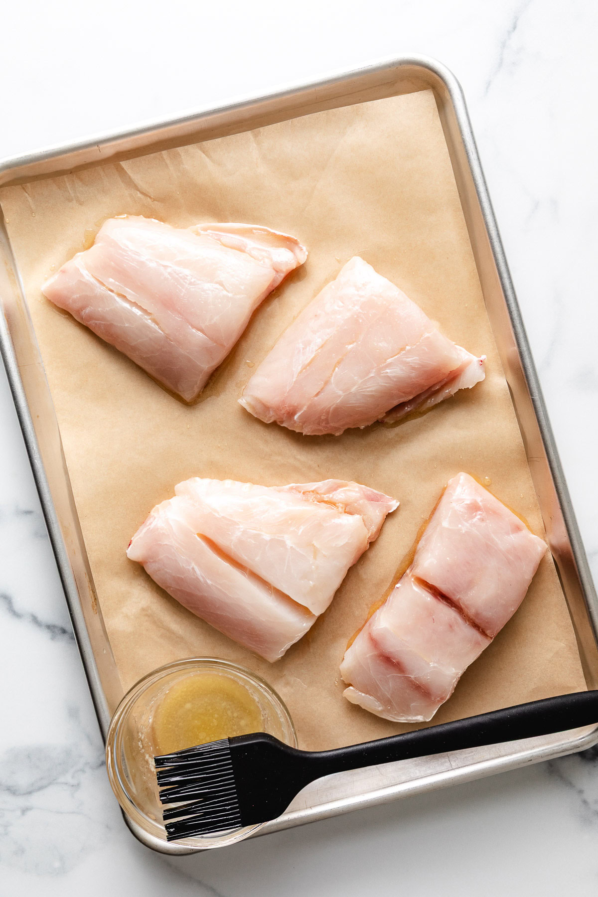 Butter spread over fish fillets.