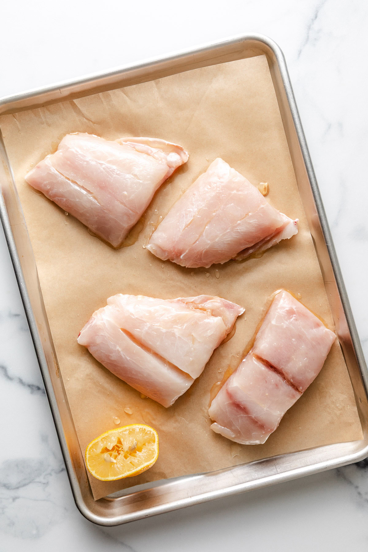 Fish fillets on a pan with lemon.