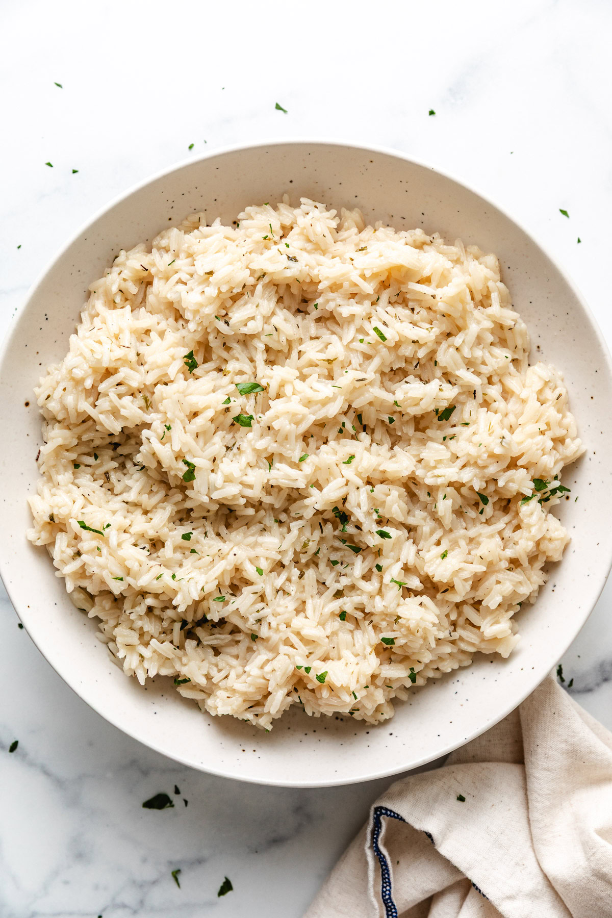 Speckled bowl filled with herb rice.