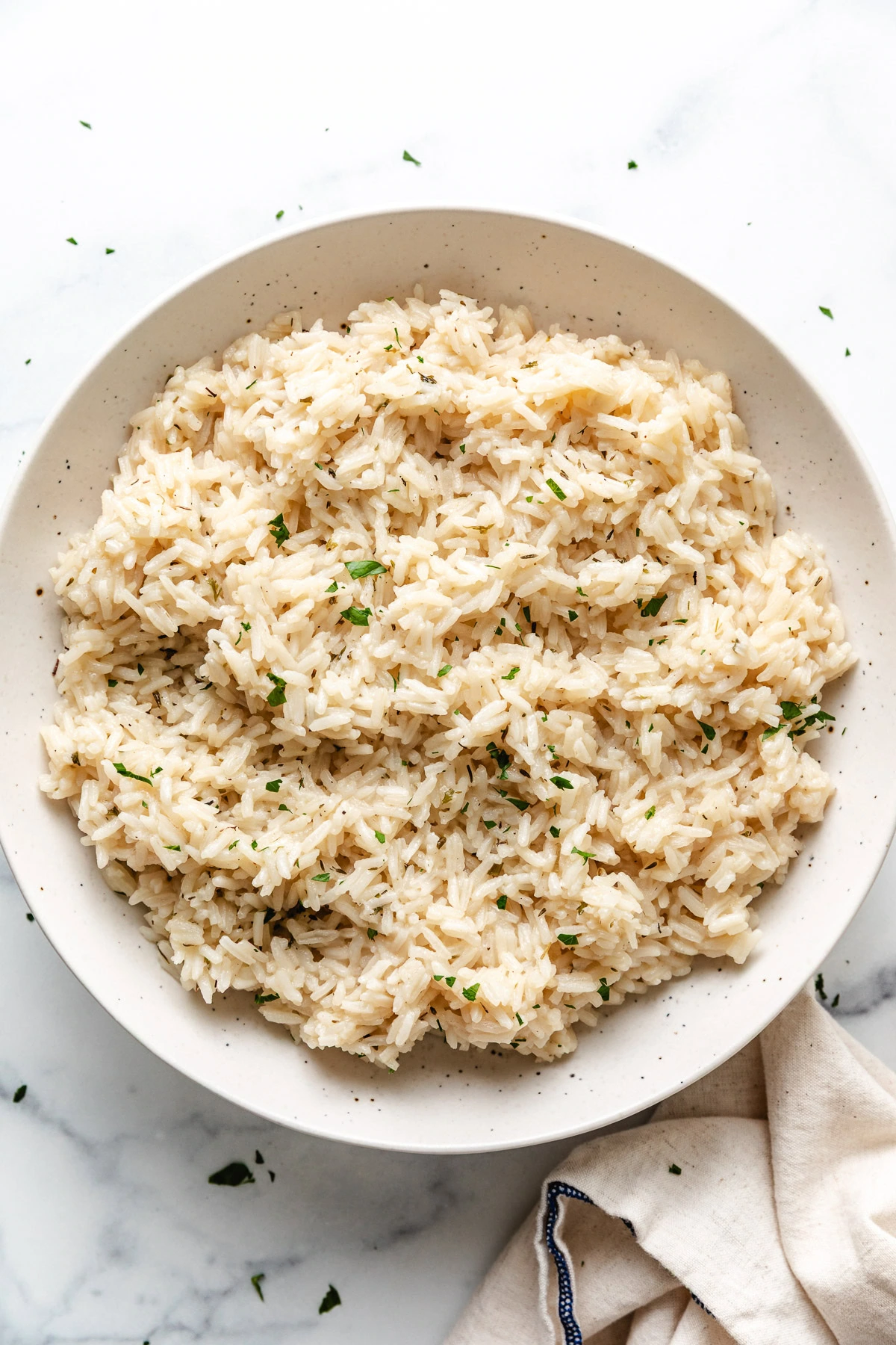Speckled bowl filled with herb rice.