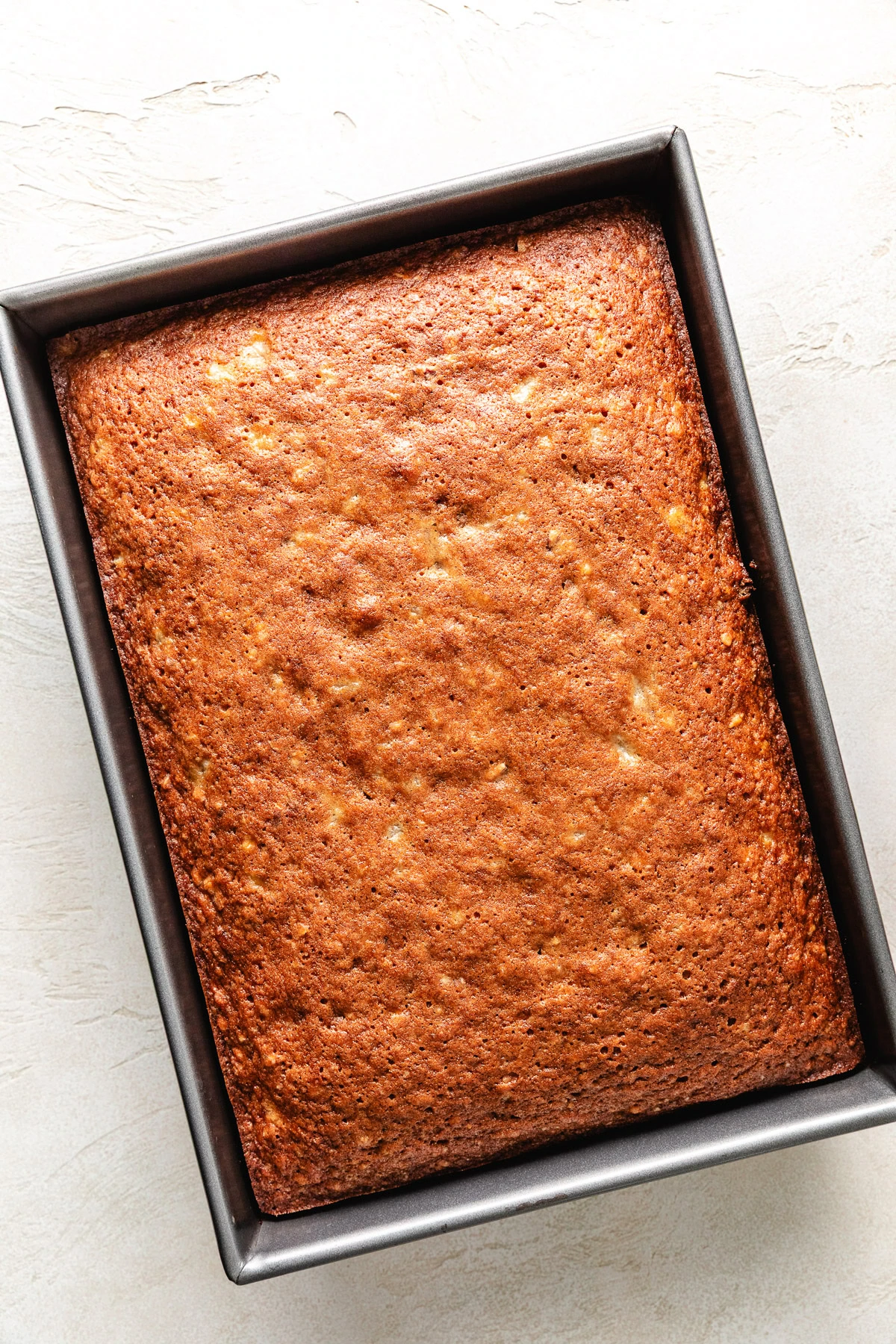 Unfrosted cake in a bowl.