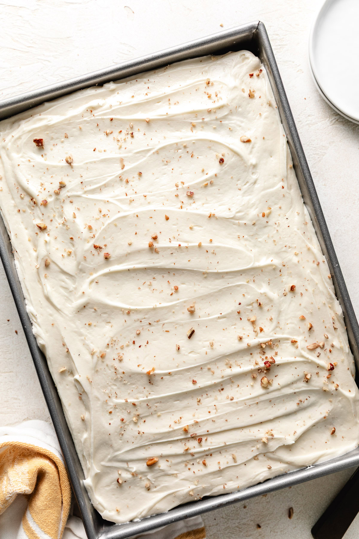 Hummingbird Cake Overhead view of frosted cake in a pan.