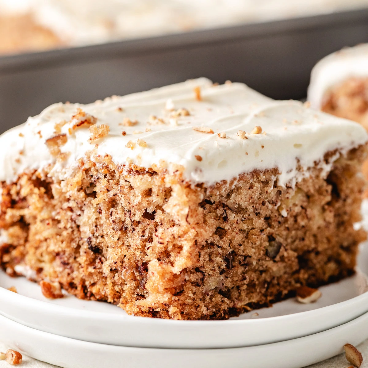 Close up view of hummingbird cake on two plates.