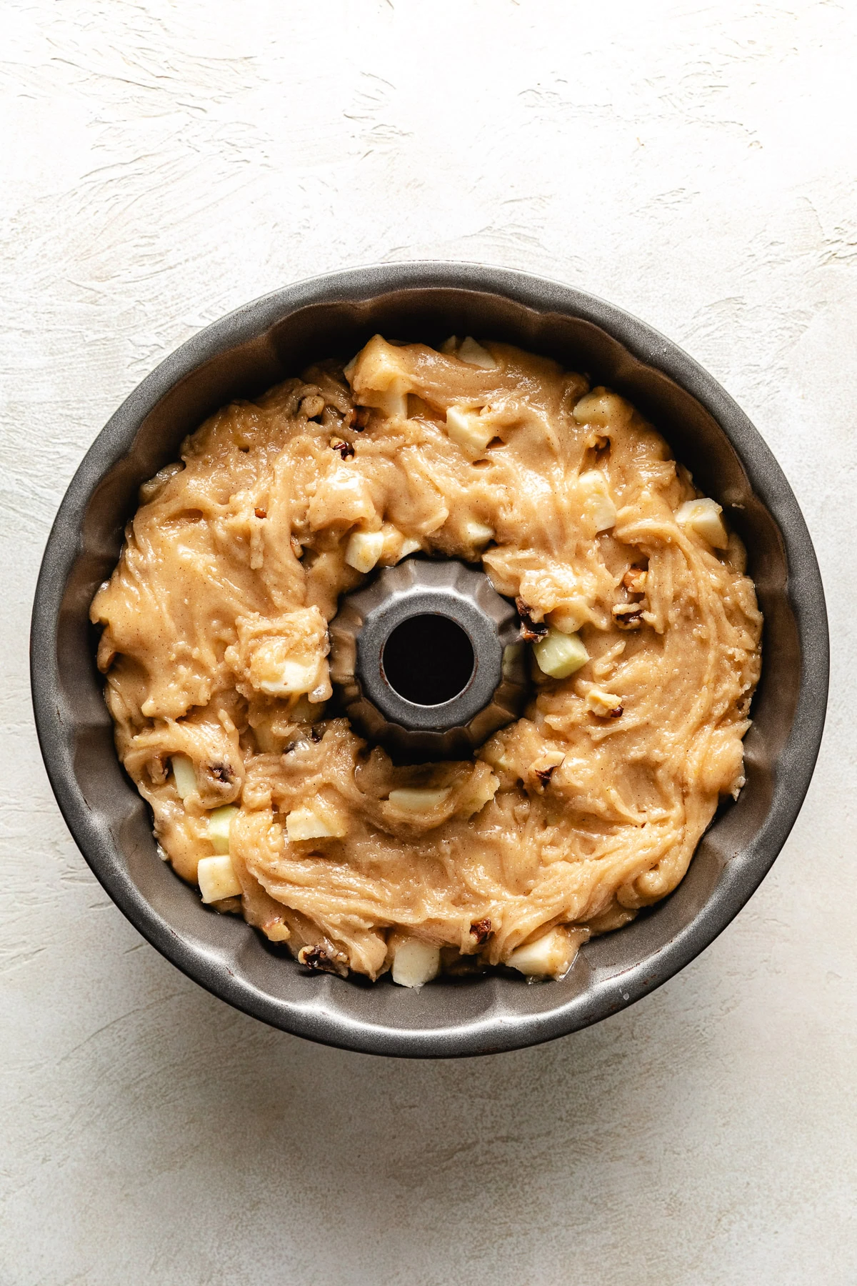 Apple cake batter in a pan.
