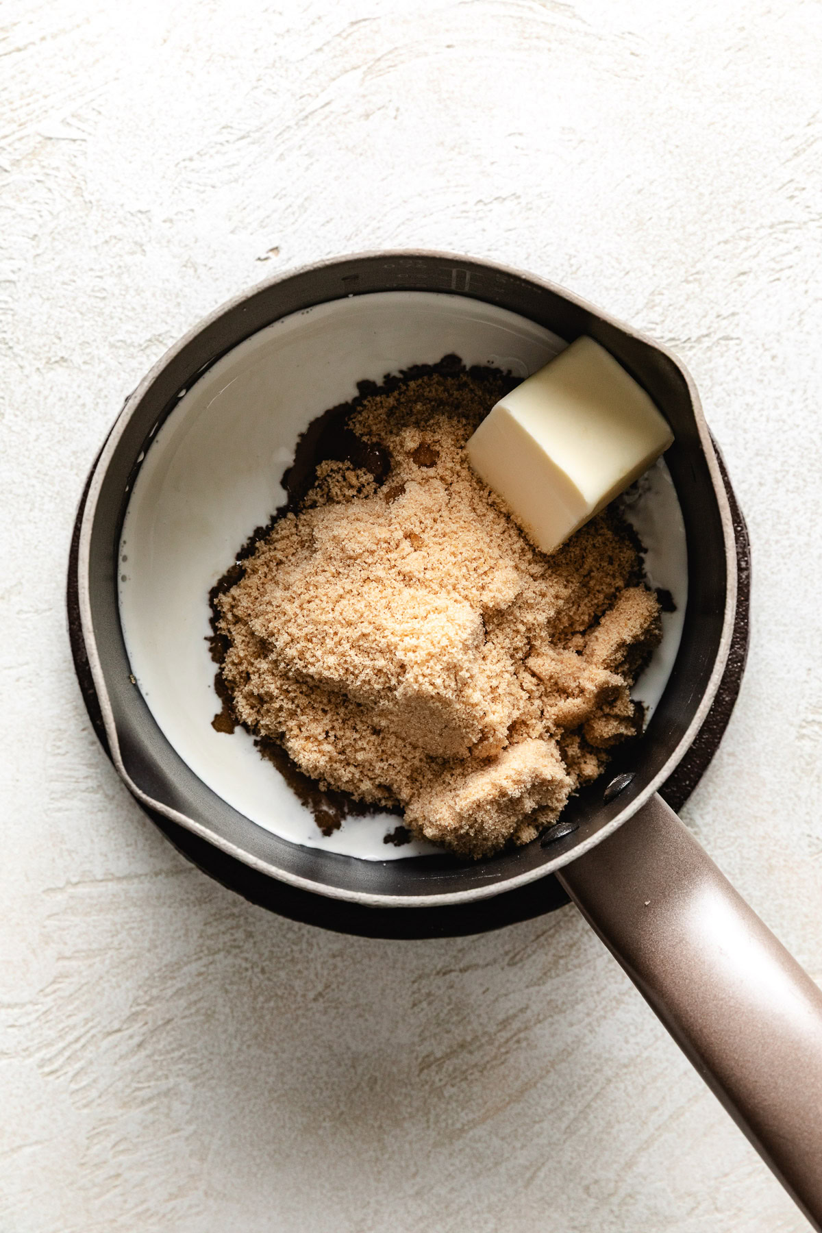 Brown sugar, cream and butter in a pan.