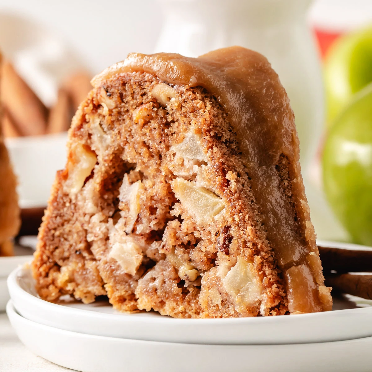 Close up view of a slice of apple bundt cake on a plate.