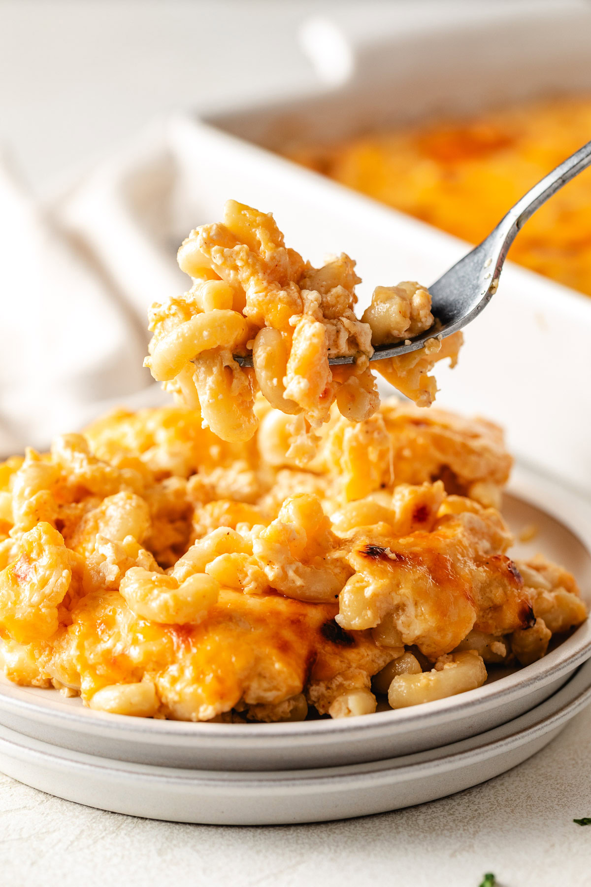 Fork holding up Southern mac and cheese.