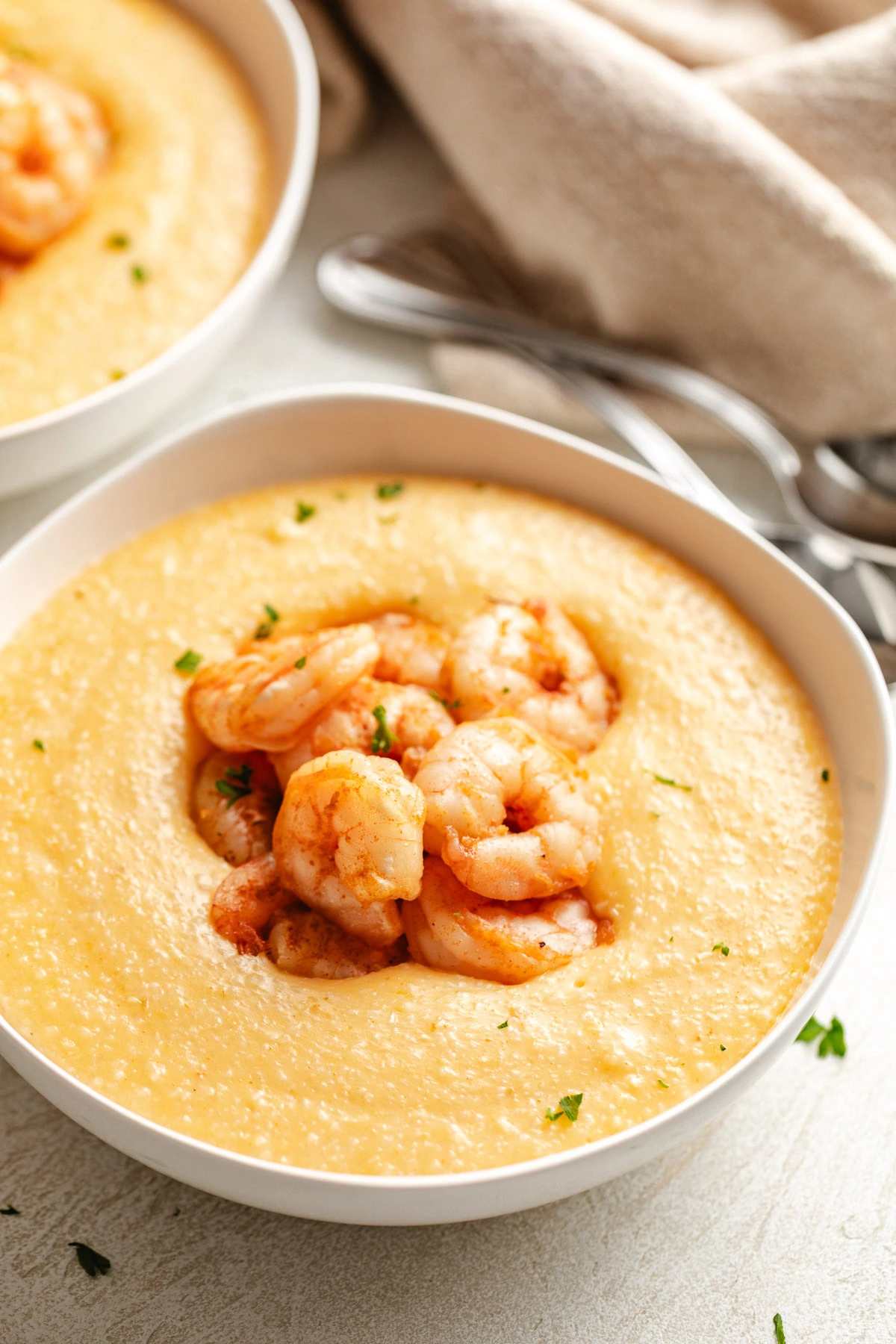 Seasoned shrimp on a bowl of grits.