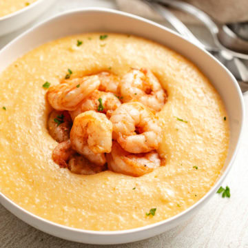 Close up view of cheesy cajun shrimp and grits.