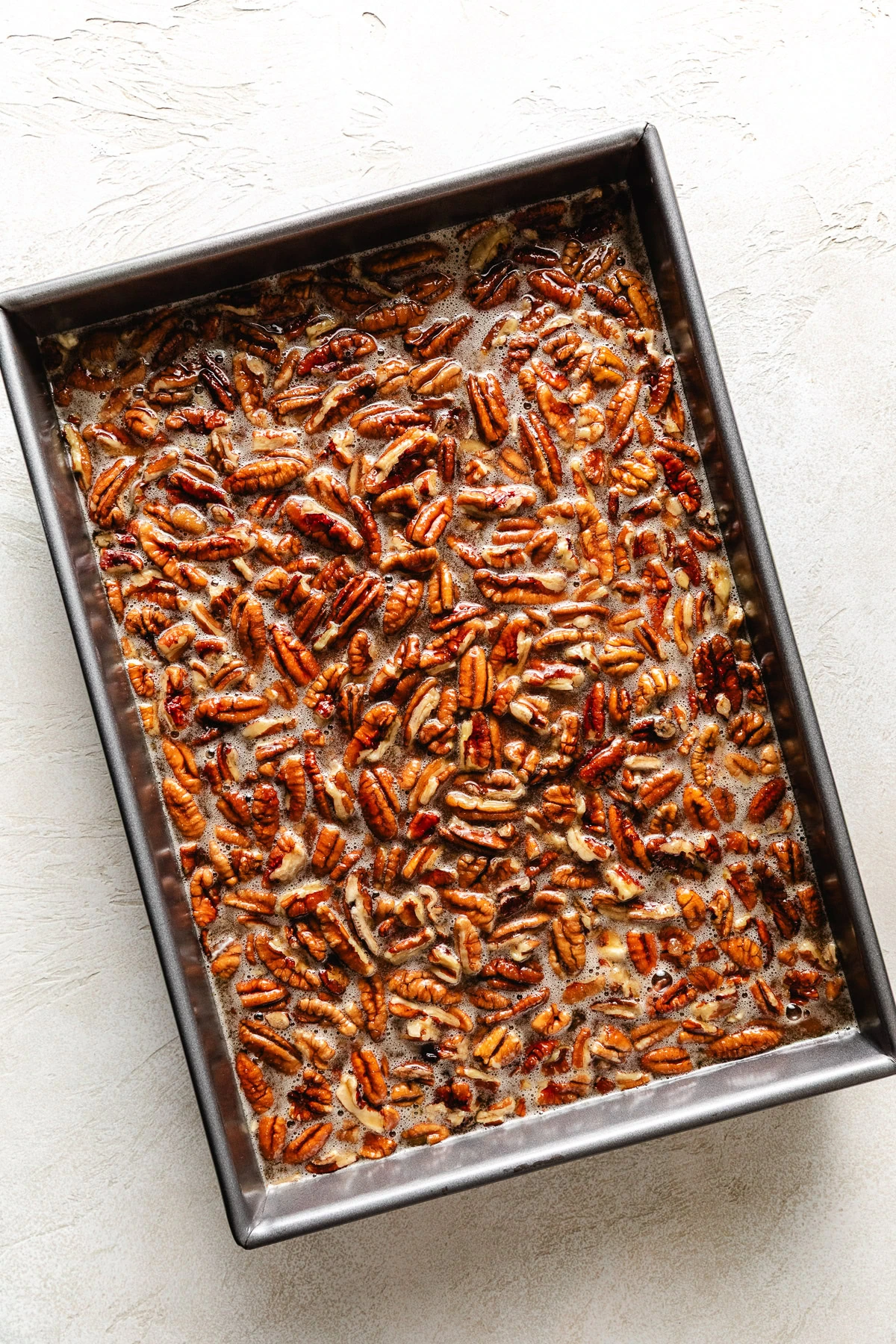 Unbaked pecan pie filling in a pan.