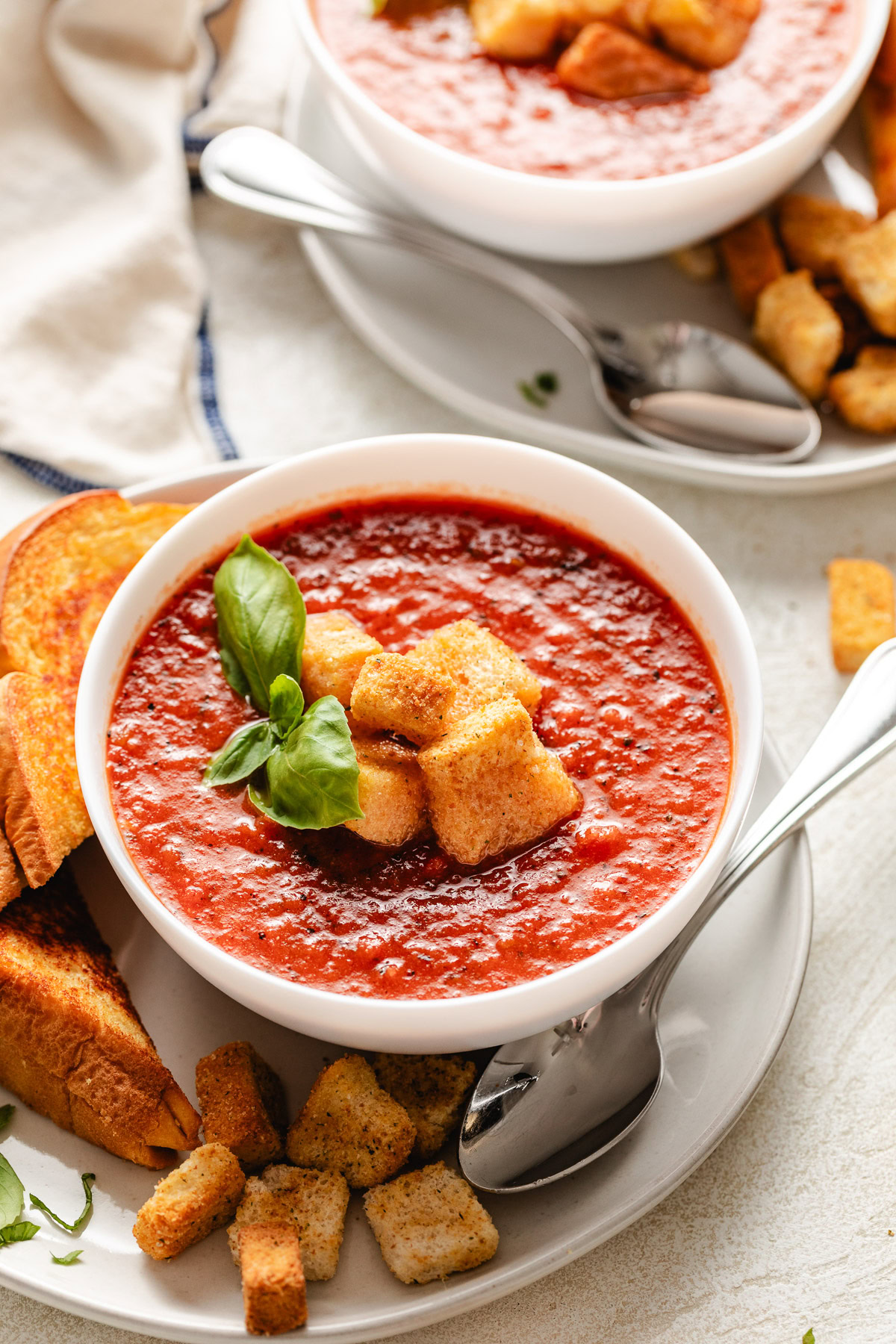 Bowl of tomato basil soup with croutons.