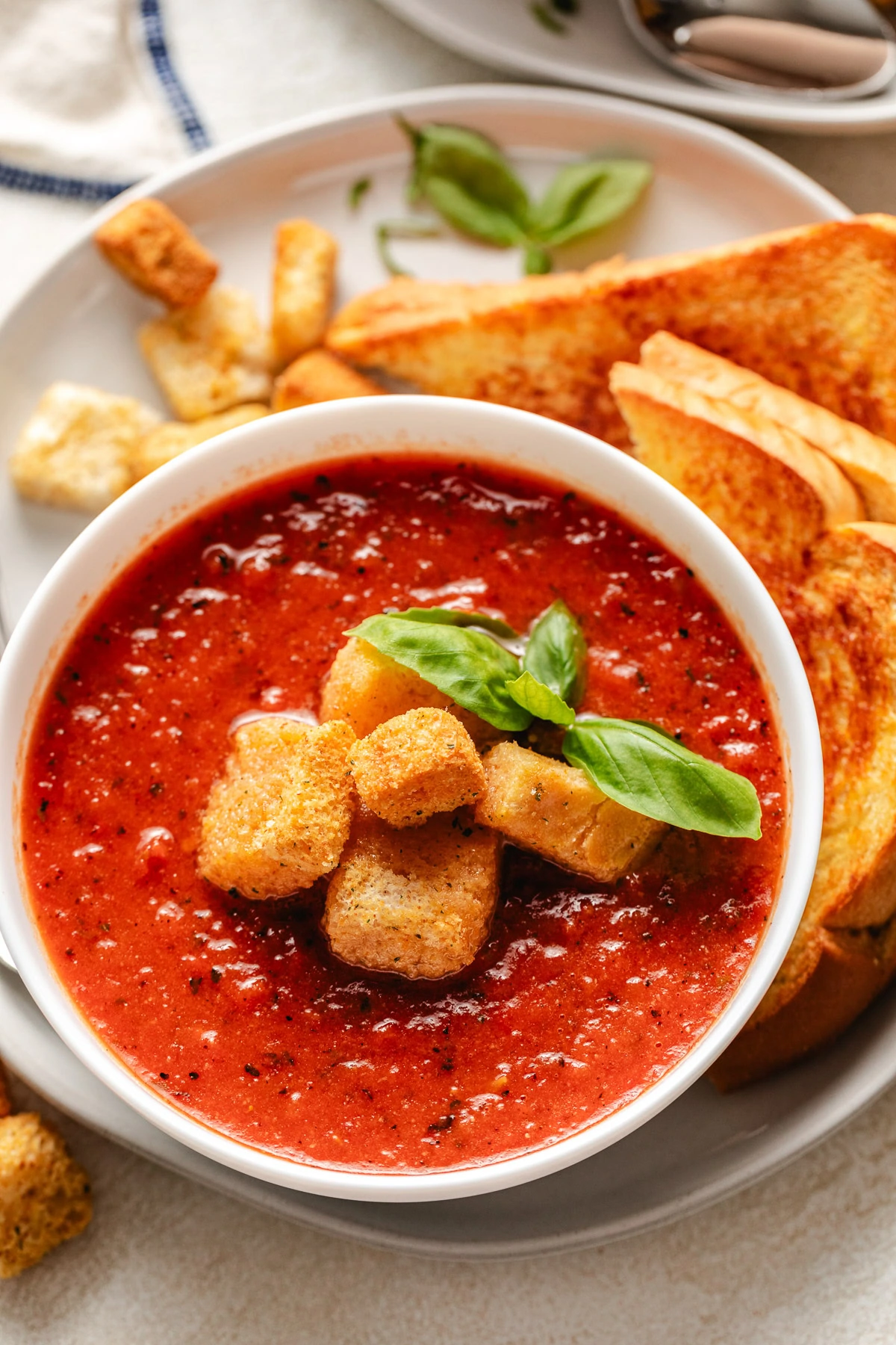 Tomato basil soup with croutons and fresh basil.