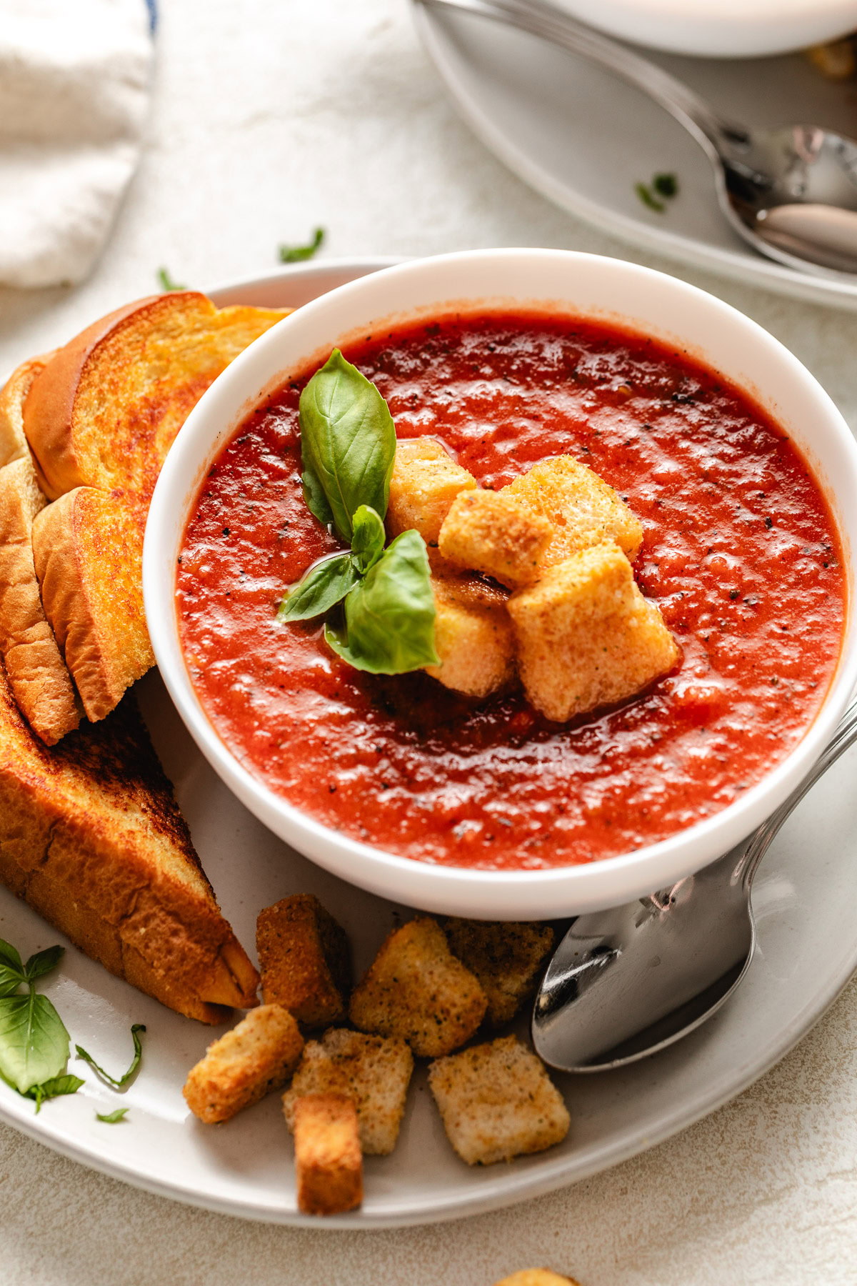 Tomato soup next to grilled cheese.